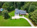 Aerial view of property showcasing manicured lawn, circular driveway and a beautiful in-ground pool at 4149 Yancey Rd, Douglasville, GA 30135