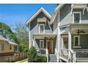 Beautiful gray two-story home showcasing charming front porches, orange front door and well-maintained landscaping at 1100 Wylie Se St # A, Atlanta, GA 30316