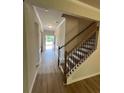 Bright entryway features wood-look floors and a staircase with iron spindles at 4520 Ajo Walk, Atlanta, GA 30331