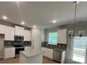 Modern kitchen with white cabinets, stainless steel appliances, and granite countertops at 4520 Ajo Walk, Atlanta, GA 30331