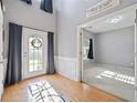 Bright foyer with hardwood floors, soaring ceilings, and a view into an adjacent room at 419 Farmwood Way, Canton, GA 30115