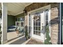 Close-up of a welcoming front door with decorative wreath, sidelights, and charming stone accents at 419 Farmwood Way, Canton, GA 30115