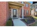 Inviting entryway with brick and stone accents, featuring a decorative front door and well-maintained landscaping at 4316 Constellation Blvd, Snellville, GA 30039