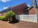 Charming brick home with a white picket fence and neat landscaping, offering great curb appeal at 119 Holiday Rd # 704, Buford, GA 30518