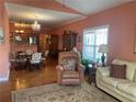 Inviting living room featuring hardwood floors, a plush sofa, a leather recliner, and access to kitchen area at 119 Holiday Rd # 704, Buford, GA 30518
