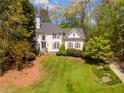 Beautifully landscaped front yard with lush green lawn and mature trees creating a private setting at 129 Ridgetree Ln, Marietta, GA 30068