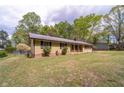 A single-story home with traditional siding and a well-maintained lawn at 284 Zion Wood Rd, Loganville, GA 30052