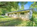 Spacious brick home with mature trees providing ample shade and a well-maintained lawn, located in a quiet neighborhood at 3150 Stonewall Tell Rd, Atlanta, GA 30349