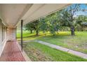Inviting covered porch with decorative tile flooring, perfect for enjoying views of the lush, green front yard at 3150 Stonewall Tell Rd, Atlanta, GA 30349