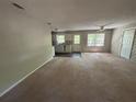 Inviting living room and kitchen area featuring neutral paint and a ceiling fan at 3347 Sir Lancelot Sw Pl, Marietta, GA 30008