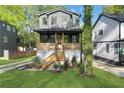 Charming two-story home with a welcoming front porch and well-maintained lawn at 644 Glendale Rd, Scottdale, GA 30079