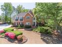 Charming brick home featuring well-maintained landscaping and a circular driveway at 860 Cramac Dr, Lawrenceville, GA 30046