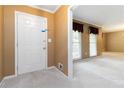 Inviting foyer featuring neutral walls and carpeting and natural light from the adjacent living room at 2343 Kings Point Dr, Dunwoody, GA 30338