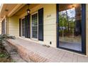 Covered front entrance with brick detail, black shutters, and a black-trimmed glass front door at 2343 Kings Point Dr, Dunwoody, GA 30338