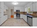 Bright kitchen featuring white cabinets, stainless steel appliances, granite counters and tile backsplash at 2979 Sweetbriar Walk, Snellville, GA 30039