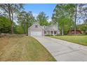Spacious home with well-maintained lawn, long driveway, attached garage, and a classic American flag at 4960 Shannon Sw Way, Mableton, GA 30126