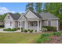 Charming single-story home featuring a manicured lawn, attached garage, and covered front porch at 4960 Shannon Sw Way, Mableton, GA 30126