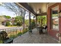 Inviting covered porch with brick flooring and comfortable seating with a view of the neighborhood at 1061 Arbor Ne Trce, Atlanta, GA 30319