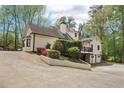 Charming home with a two-car garage, beautiful landscaping, and mature trees at 2972 Nw Stilesboro Nw Rd, Kennesaw, GA 30152