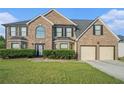 Charming brick home featuring a well-maintained lawn and an attached two-car garage at 4180 West Stubbs Rd, College Park, GA 30349