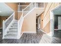 Bright foyer with hardwood floors and an elegant staircase leading to the upper level at 4180 West Stubbs Rd, College Park, GA 30349