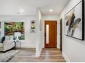Bright entryway featuring modern decor, a wood door with glass, and sleek wood floors at 2685 Glenvalley Dr, Decatur, GA 30032