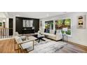 Stylish living room features large windows, hardwood floors, contemporary furniture, and recessed lighting at 2685 Glenvalley Dr, Decatur, GA 30032