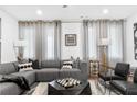 A spacious living room featuring a comfortable gray sectional and modern decor at 388 Pratt Se Dr # 2123, Atlanta, GA 30315