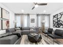 A spacious living room featuring a comfortable gray sectional and modern decor at 388 Pratt Se Dr # 2123, Atlanta, GA 30315