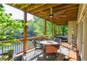 A lovely back porch featuring a ceiling fan and wicker outdoor furniture overlooking a beautiful lake at 4730 W Forest Peak, Marietta, GA 30066