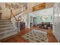 Spacious foyer featuring hardwood floors, an elegant staircase, and an open view to the dining area at 5604 Mccullers Ln, Loganville, GA 30052