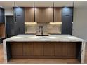 Stylish kitchen with marble countertop island and contemporary hanging lights at 820 Moores Mill Nw Rd, Atlanta, GA 30327