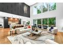 Open-concept living room with a large window, plush sofa, and modern decor at 820 Moores Mill Nw Rd, Atlanta, GA 30327