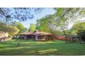 Expansive backyard with lush green grass and a screened in porch, great for entertaining at 2685 Buena Vista Ave, Doraville, GA 30340