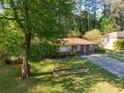 Well-maintained brick home featuring a large front yard and mature trees at 2685 Buena Vista Ave, Doraville, GA 30340