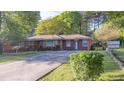 Charming brick ranch home featuring a long driveway and well-maintained landscaping at 2685 Buena Vista Ave, Doraville, GA 30340