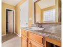 Bathroom featuring vanity with granite countertop, and glass block window at 3243 Timber Rdg, College Park, GA 30349