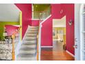 Inviting entryway with staircase, colorful walls, and hardwood floors at 3243 Timber Rdg, College Park, GA 30349