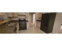 Functional kitchen featuring tile floors and modern black appliances at 3371 Metro Way, Snellville, GA 30039