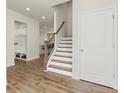 Welcoming entryway featuring hardwood floors, a staircase with a wooden handrail, and a convenient mudroom area at 350 Hayden Cir, Woodstock, GA 30189