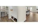 Convenient mudroom with built-in bench and storage, adjacent to a half bath and an open-concept living area at 350 Hayden Cir, Woodstock, GA 30189