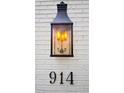 Close-up of a gas lantern, house number 914, on a white brick wall at 914 Denmeade Sw Walk, Marietta, GA 30064