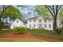 Beautiful two-story home with white brick and lush green landscaping at 914 Denmeade Sw Walk, Marietta, GA 30064