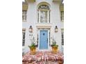 Inviting front entrance with a light blue door, brick steps and decorative planters at 914 Denmeade Sw Walk, Marietta, GA 30064