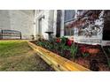 Charming front yard with fresh mulch, colorful tulips, and a wooden retaining wall, leading to the house at 2270 Fenwick Pointe Sw, Marietta, GA 30064