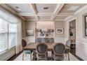 Formal dining room with wainscoting, coffered ceilings, elegant lighting, and neutral decor at 2631 Moon Chase Lane, Buford, GA 30519