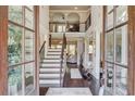Elegant foyer with hardwood floors, staircase, soaring ceilings, and view to upper level at 2631 Moon Chase Lane, Buford, GA 30519
