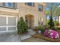 Inviting home entrance with brick facade, manicured landscaping, and an ADT security sign at 2890 Canter Meadow Dr, Cumming, GA 30040
