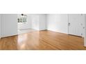 Bright living room featuring gleaming hardwood floors and a white front door at 1468 Briarwood Ne Rd # 602, Atlanta, GA 30319