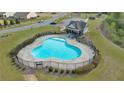 Aerial view of the community pool, featuring a fenced area and a nearby shaded pavilion at 4655 Bluffton Ct, Cumming, GA 30028